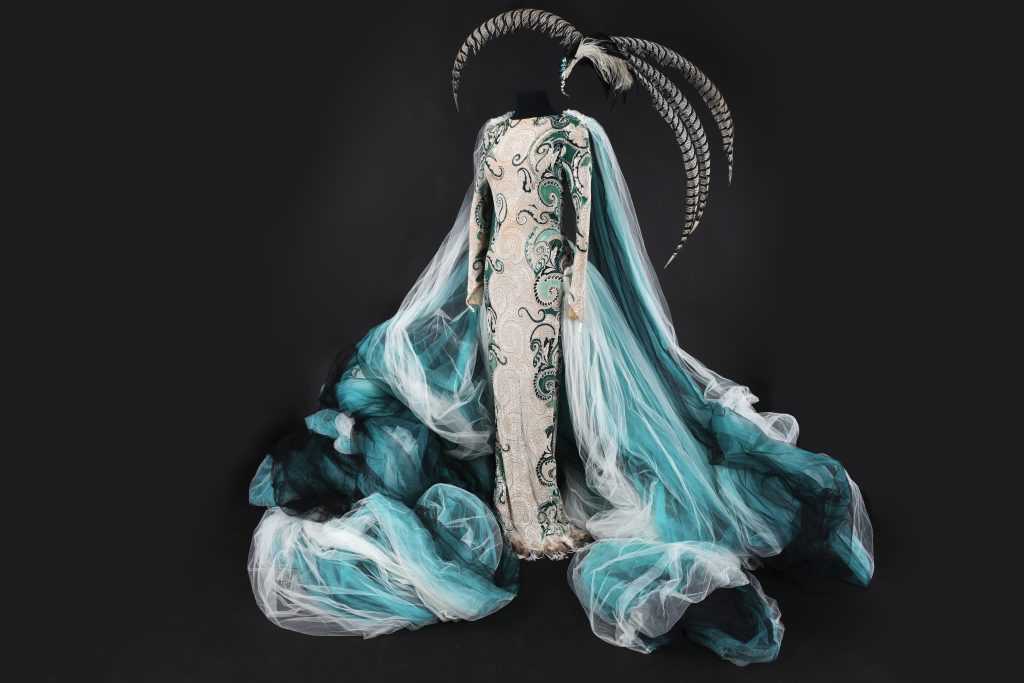 Elaborate costume with swirling cape of light blue and white